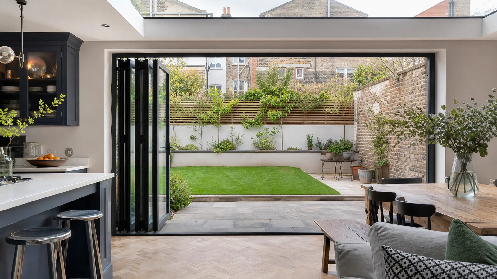 Aluminium bifold doors installed in a kitchen extension opening onto a garden